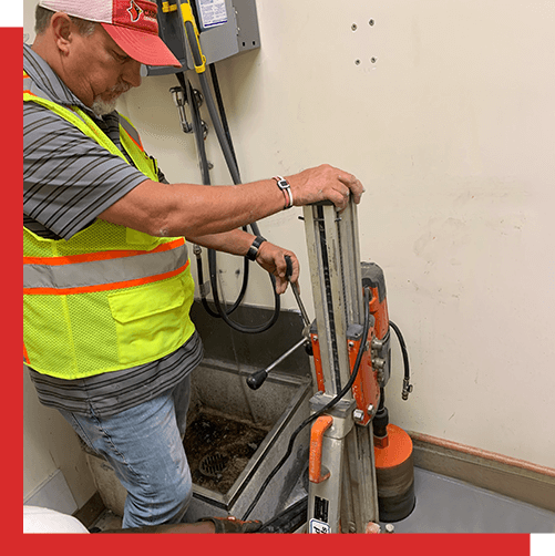Photo of cardinal contractor holding a drill press